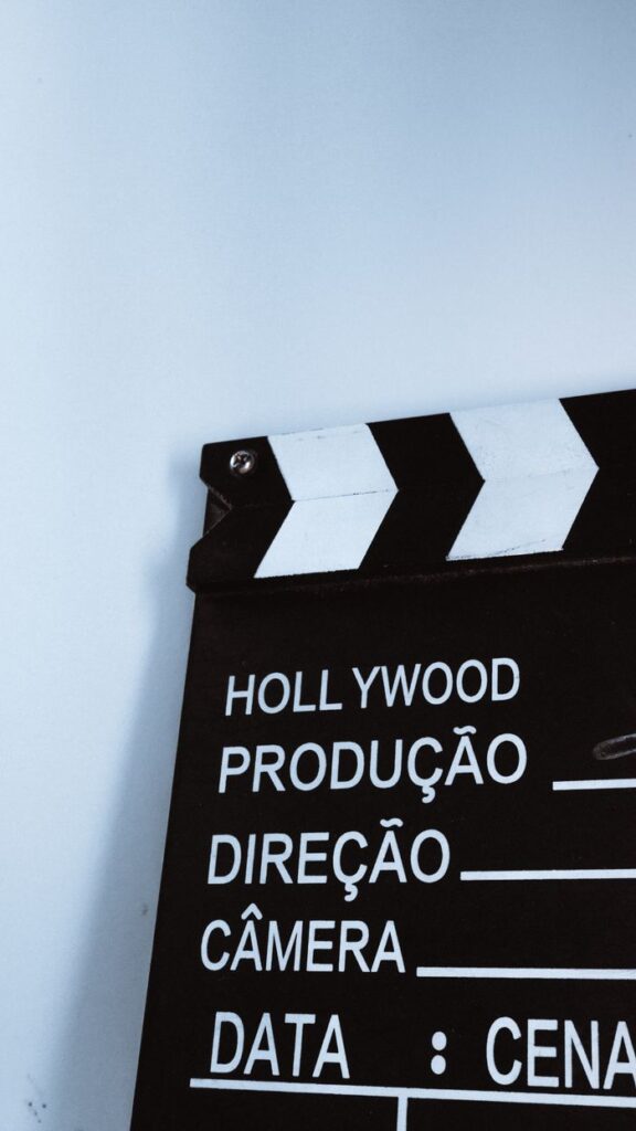 Close-up vertical shot of a clapperboard with text, ideal for film and media themes.