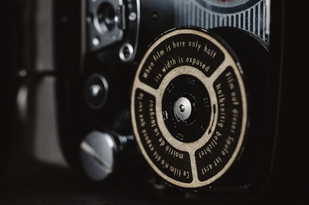 Detailed view of a classic camera film mechanism with text on the dial.